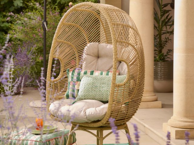 Garden egg chair with pastel cushions by Cox & Cox