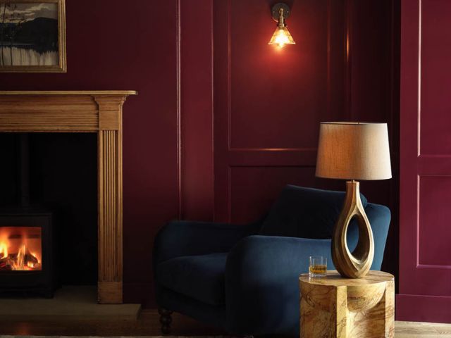 Red cosy living room by Industville