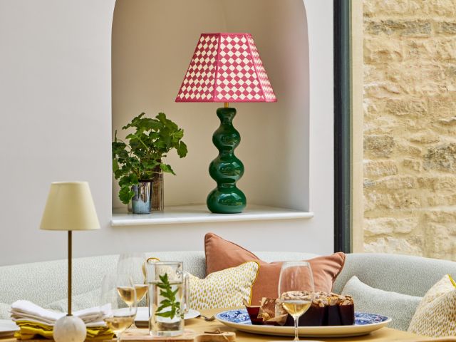 Dining table set up with green base and red checked lampshade from Pooky