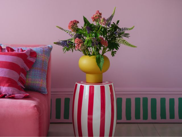 Pink living room with striped painted border by Benjamin Moore