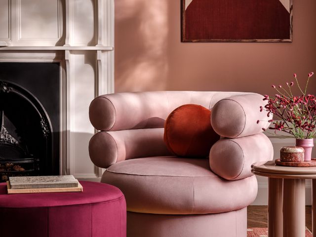 Pink chair with red cushion by Sofology