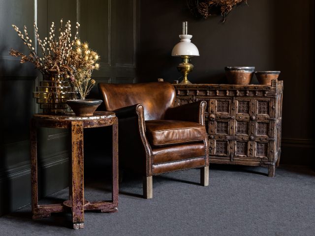 Leather armchair and wooden furniture by Peppermill Interiors