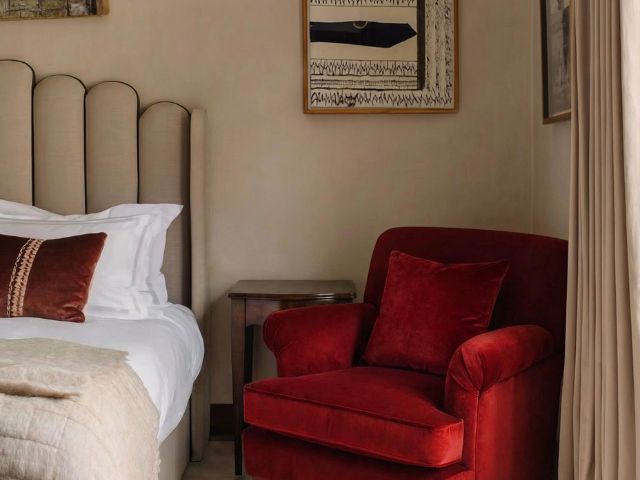 Red armchair in a calming bedroom