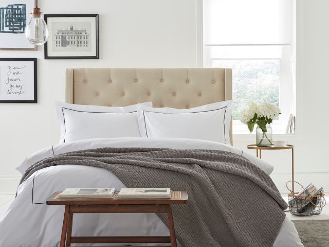 Happy pillows on a lovely made bed
