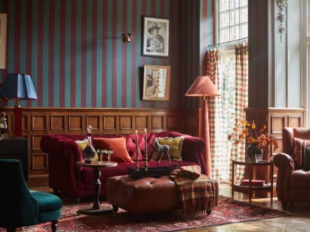 Striped wallpaper paneling and red sofa in living room set up by DFS