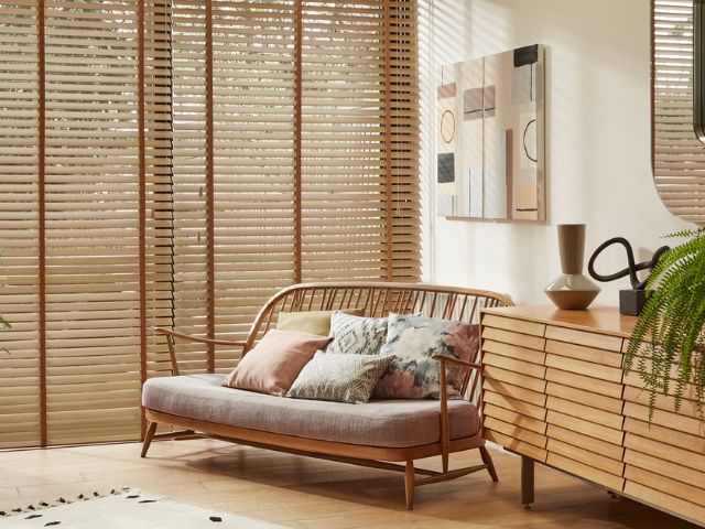 Wooden blinds in a calming living room by Hillarys