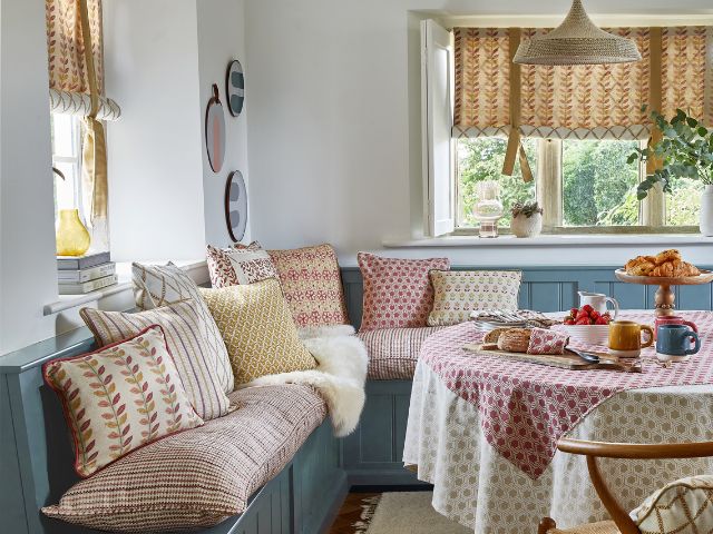 Banquet seating with patterned cushions by Prestigious Textiles