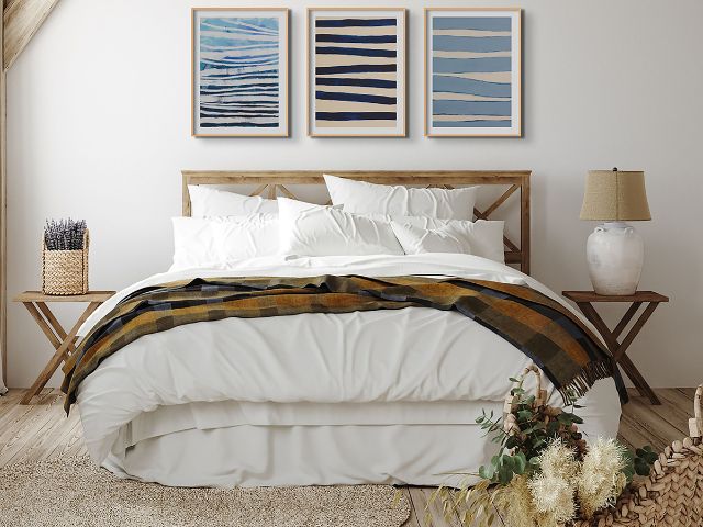 Blue wall art in a blue and white bedroom
