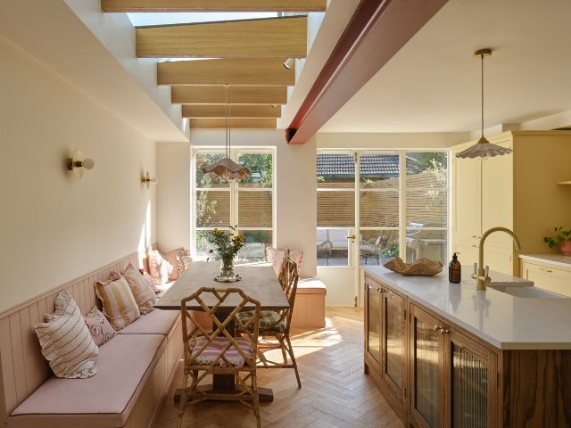 Family kitchen with banquette seating by Olive & Barr