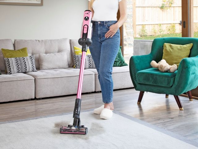 Woman hoovering her living room