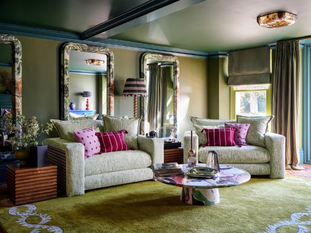 Green living room with jewel toned cushions by Sofology