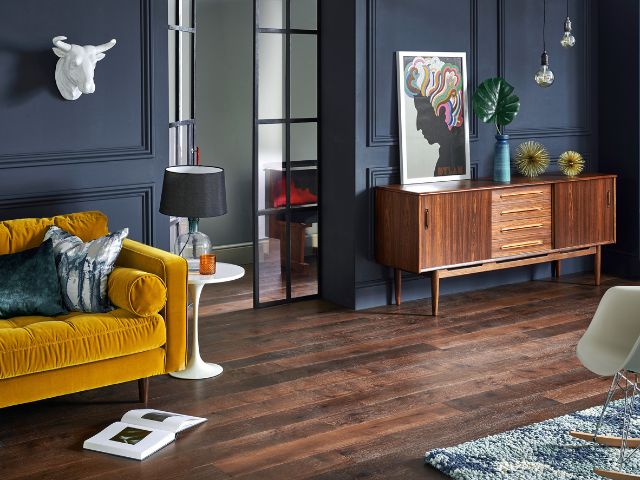 Indigo walls mixed with dark wood flooring